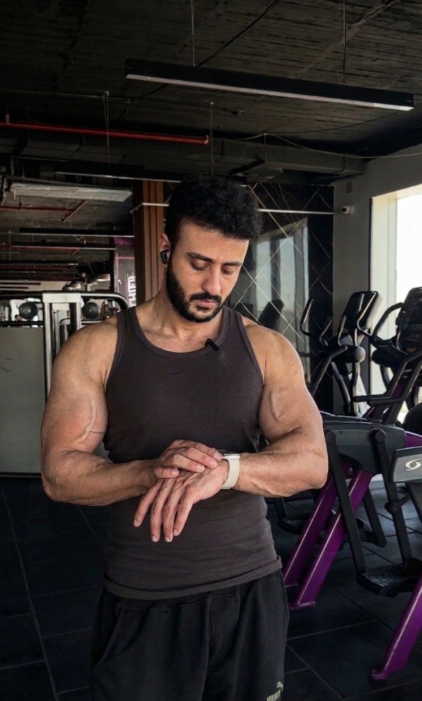 Dagher Mahmoud checking his watch in the gym.