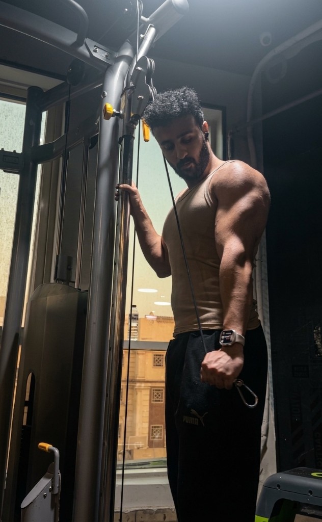 Dagher Mahmoud on a cable machine.