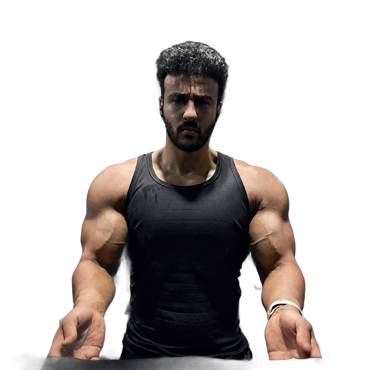 Dagher Mahmoud facing the camera in a black training vest, arms braced wide.